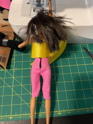 Rear view of a Barbie doll wearing hand-made pink pants