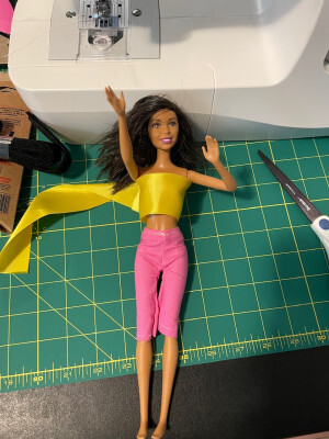 Front view of a Barbie doll wearing hand-made pink pants
